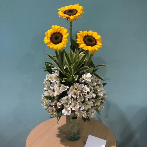 Vase of three sunflowers