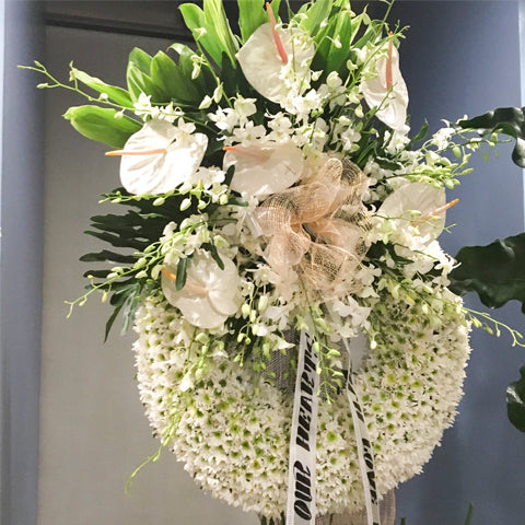 Circular wreath radost with white anthuriums and white orchids