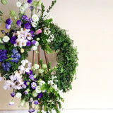 Green wreath with purple roses