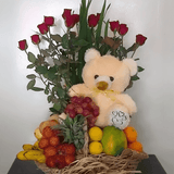Basket of fruit with a twelve red roses and bear